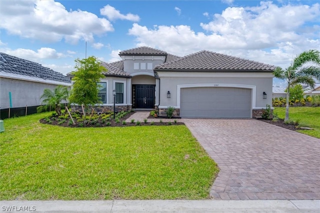 mediterranean / spanish-style house with a front lawn and a garage