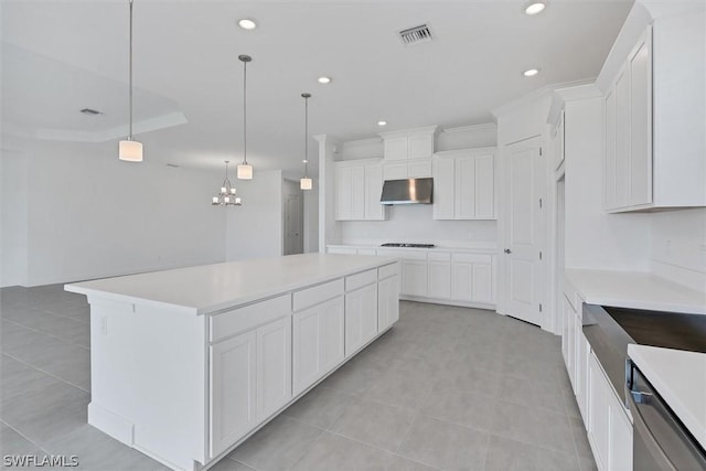 kitchen with white cabinetry, gas stovetop, hanging light fixtures, a chandelier, and a center island