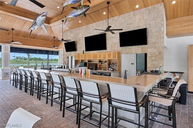 view of patio / terrace with ceiling fan and a bar