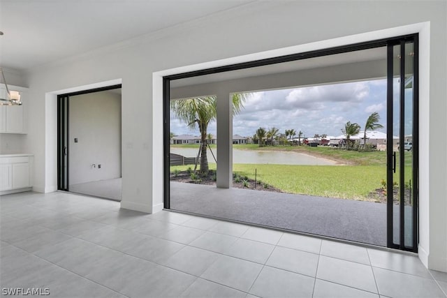 doorway to outside featuring plenty of natural light, crown molding, a water view, and an inviting chandelier