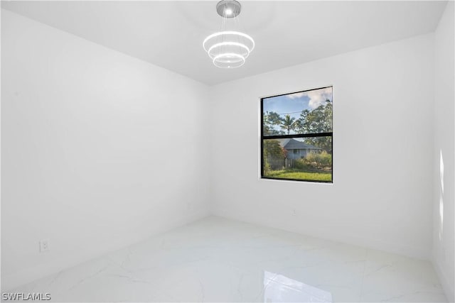 empty room featuring an inviting chandelier