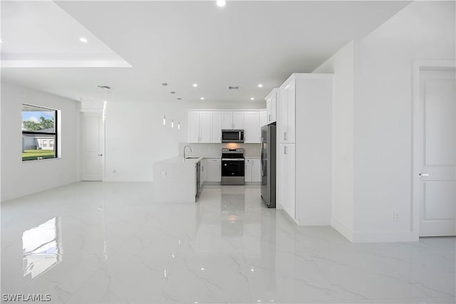 kitchen with white cabinets, appliances with stainless steel finishes, and sink