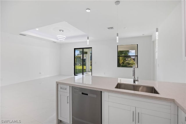 kitchen with stainless steel dishwasher, decorative light fixtures, white cabinetry, and sink