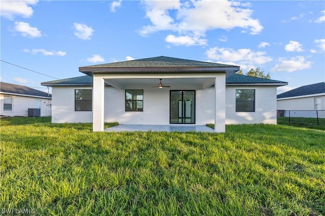 back of house featuring a lawn, ceiling fan, central AC unit, and a patio area