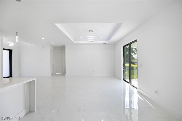 unfurnished room with a raised ceiling