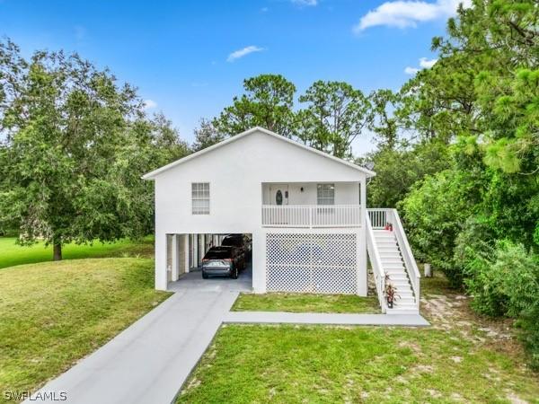 exterior space featuring a carport and a yard