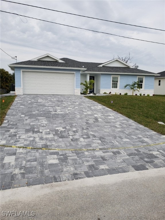 single story home featuring a front yard and a garage