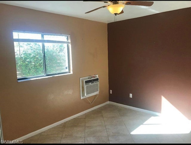 tiled spare room featuring ceiling fan and a wall mounted air conditioner