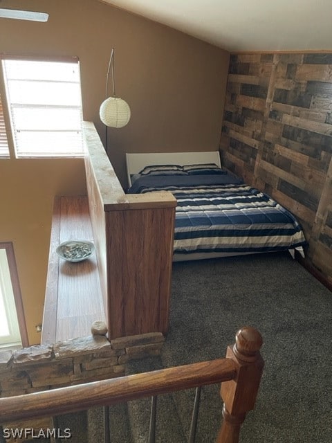 bedroom featuring multiple windows and dark carpet