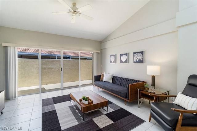 living room featuring ceiling fan, light tile patterned floors, and vaulted ceiling