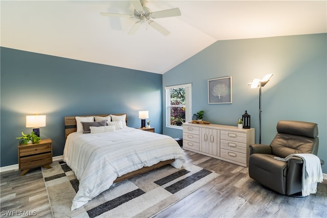 bedroom featuring ceiling fan, lofted ceiling, and hardwood / wood-style floors