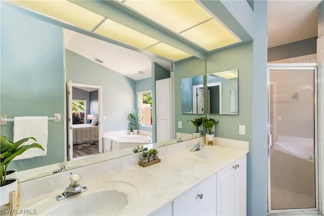 bathroom featuring walk in shower, vanity, and vaulted ceiling