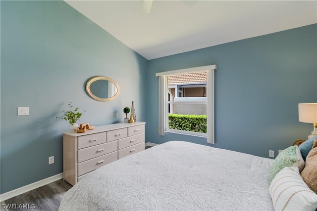 bedroom featuring ceiling fan, vaulted ceiling, and dark wood-type flooring