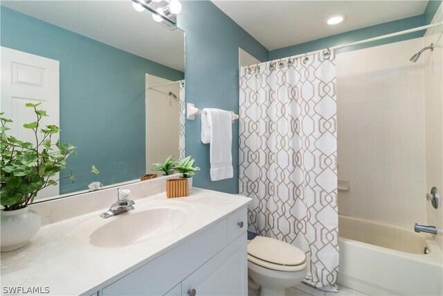 full bathroom featuring toilet, vanity, and shower / tub combo with curtain