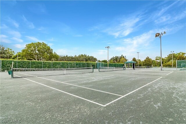 view of tennis court featuring a gazebo