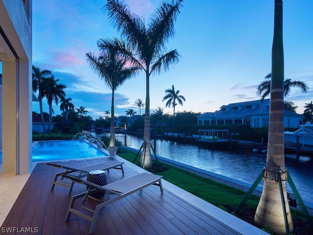 dock area with pool water feature and a water view