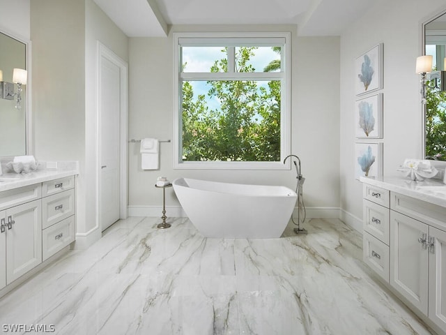 bathroom featuring vanity and a tub to relax in