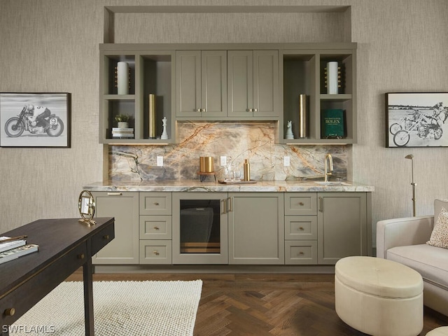 bar featuring gray cabinets, dark parquet flooring, sink, and light stone counters