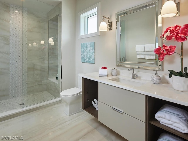 bathroom featuring a shower with door, vanity, and toilet