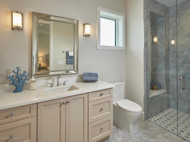 bathroom with vanity, a shower with shower door, and toilet