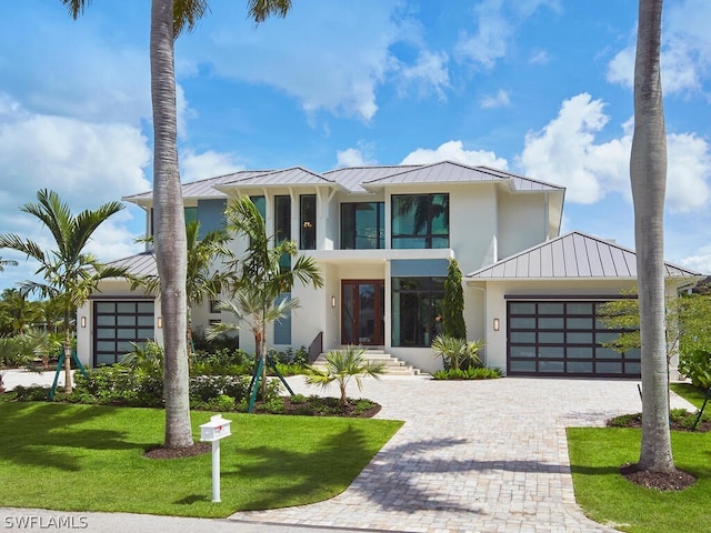 view of front facade with a garage and a front lawn