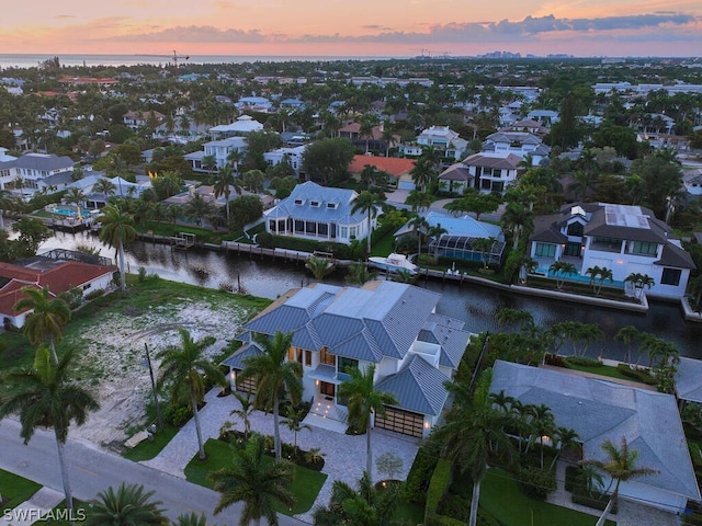 aerial view at dusk with a water view