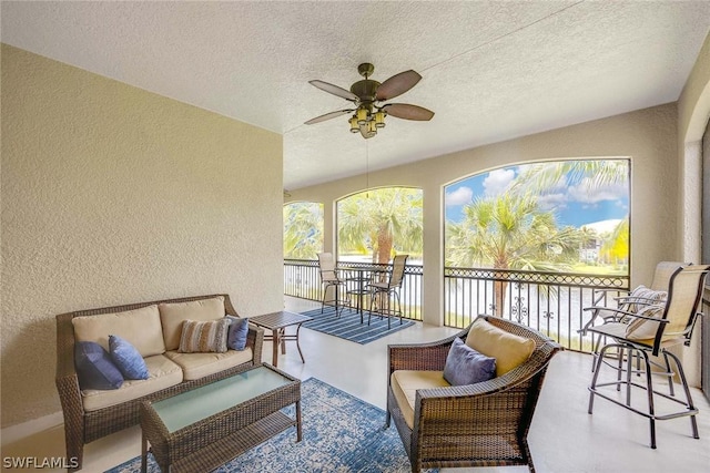 sunroom featuring ceiling fan