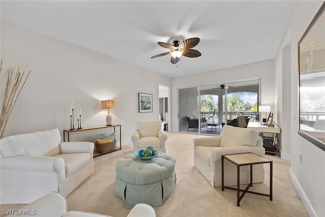 carpeted living room with ceiling fan