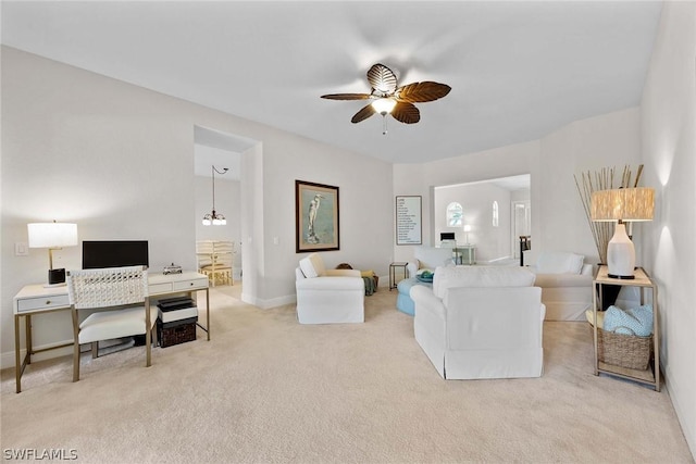 carpeted living room featuring ceiling fan