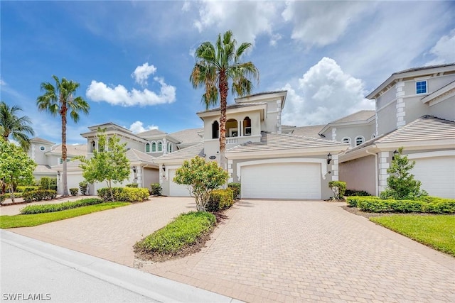 mediterranean / spanish home with a garage