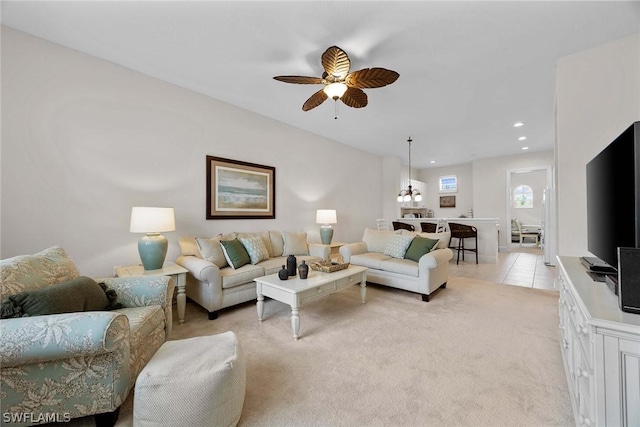 living room with ceiling fan and light colored carpet