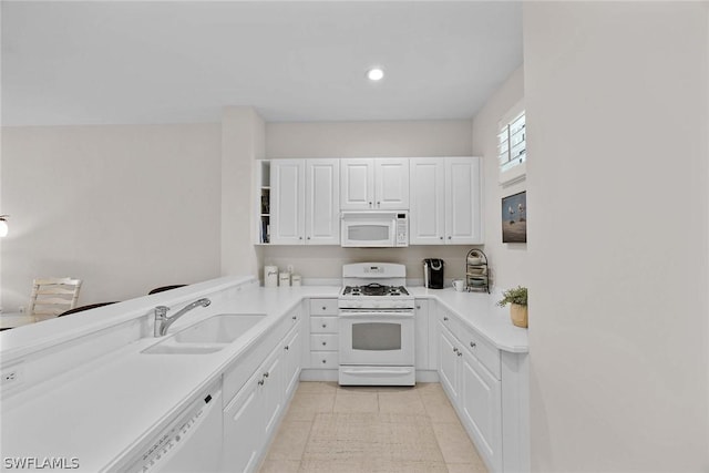 kitchen featuring white cabinets, white appliances, sink, and light tile patterned floors