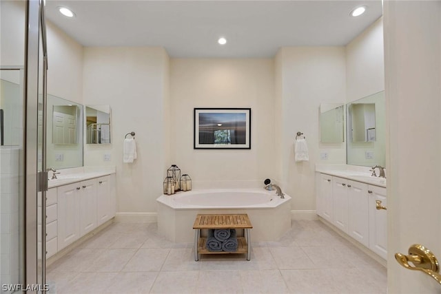 bathroom with tile patterned flooring, vanity, and a bathtub