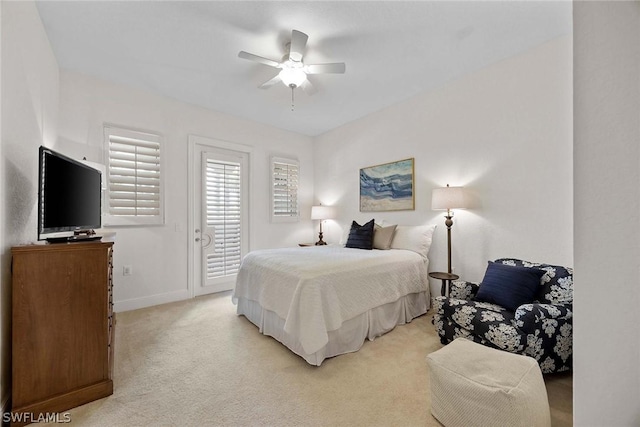 bedroom with light carpet, access to exterior, and ceiling fan