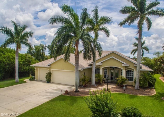 ranch-style home with a garage and a front yard