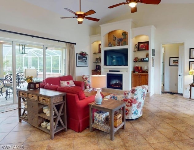 living room with built in shelves, ceiling fan, and light tile floors