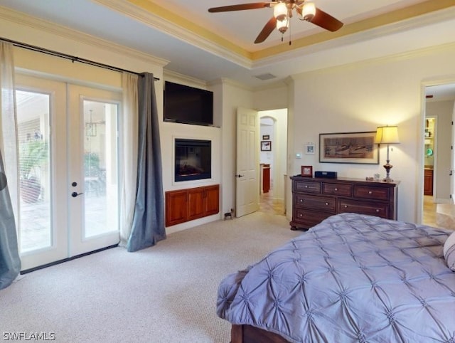 carpeted bedroom with ceiling fan, multiple windows, french doors, and access to exterior