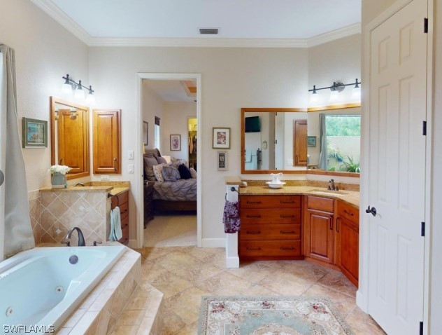 bathroom with tile floors, ornamental molding, tiled bath, and vanity