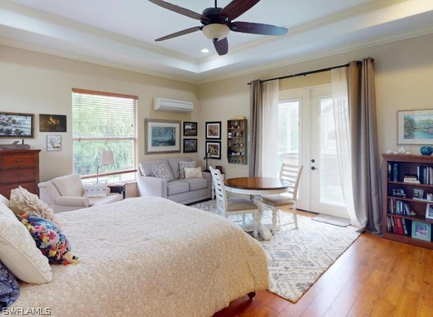 bedroom featuring ceiling fan, french doors, hardwood / wood-style floors, a wall unit AC, and access to exterior