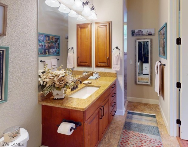 bathroom with vanity and tile floors