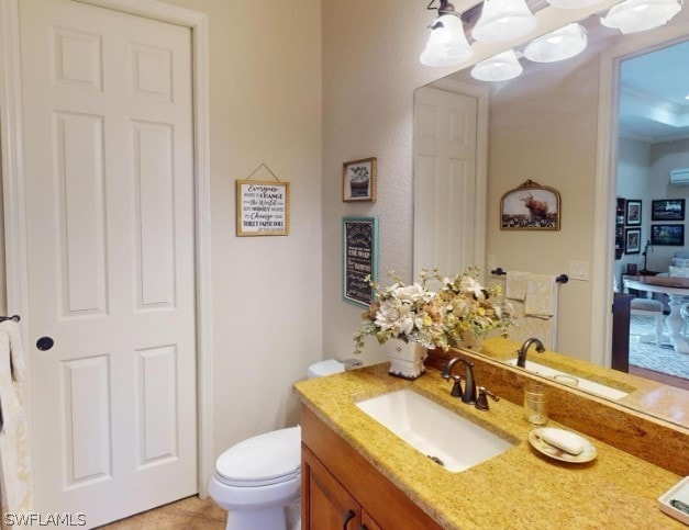 bathroom with vanity with extensive cabinet space, tile flooring, and toilet