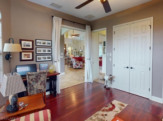 home office with hardwood / wood-style flooring and ceiling fan