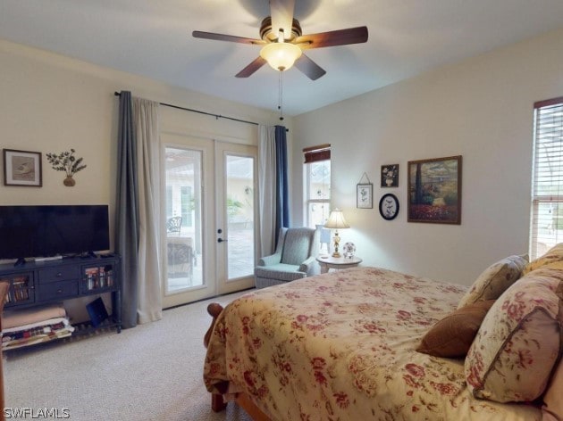 bedroom with french doors, ceiling fan, access to exterior, carpet, and multiple windows