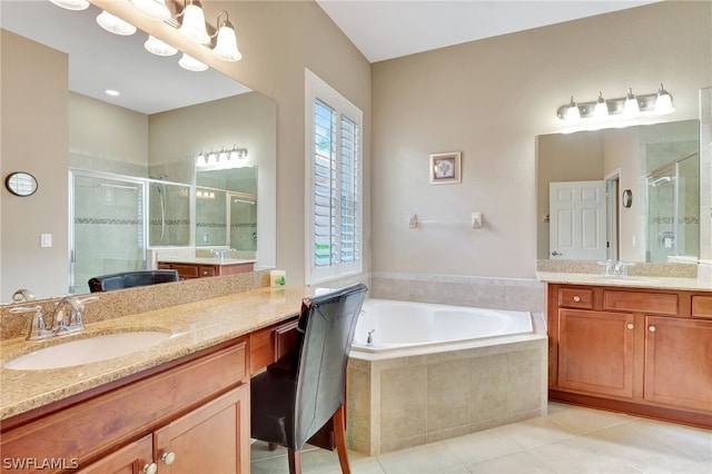 bathroom featuring tile patterned floors, vanity, and shower with separate bathtub