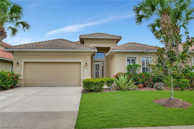 mediterranean / spanish house featuring a front yard and a garage