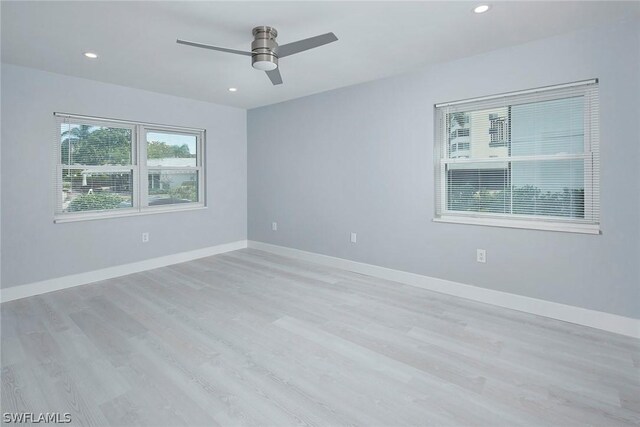 spare room with light hardwood / wood-style flooring and ceiling fan