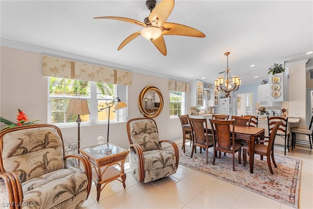 dining space featuring ceiling fan with notable chandelier, a wealth of natural light, crown molding, and light tile patterned flooring