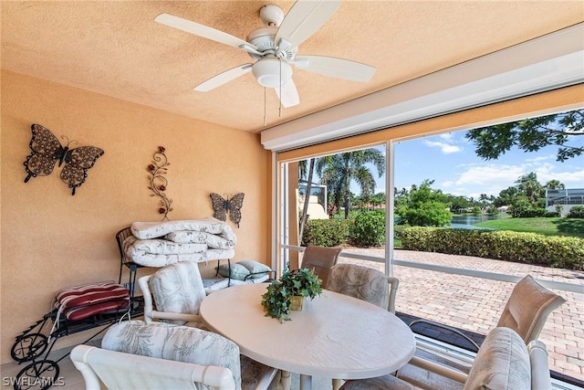 sunroom featuring ceiling fan