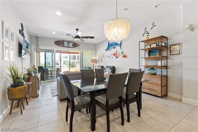 tiled dining space with ceiling fan with notable chandelier