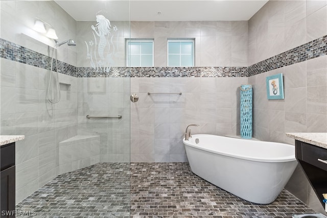 bathroom with vanity, tile walls, and plus walk in shower